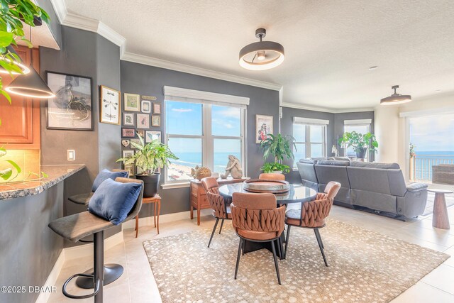 2515 S Atlantic Ave Unit 703, Daytona Beach, FL 32118 - dining room with light tile patterned flooring, ornamental molding, a textured ceiling, and a water view
