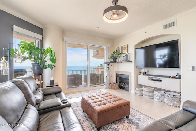2515 S Atlantic Ave Unit 703, Daytona Beach, FL 32118 - living area with a tile fireplace, tile patterned floors, ornamental molding, and a textured ceiling