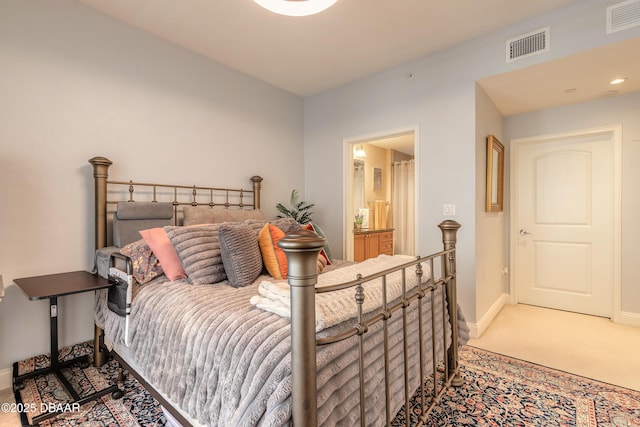 2515 S Atlantic Ave Unit 703, Daytona Beach, FL 32118 - carpeted bedroom with baseboards and connected bathroom