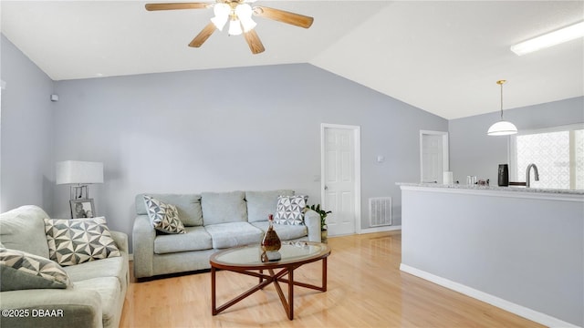 4 Starling Dr, Daytona Beach, FL 32117 - living room with lofted ceiling, light wood-style floors, a ceiling fan, and baseboards