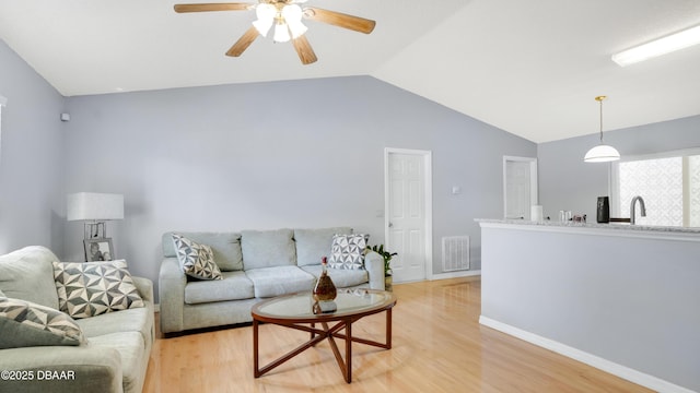 4 Starling Dr, Daytona Beach, FL 32117 - living area featuring vaulted ceiling, light wood-style floors, ceiling fan, and baseboards