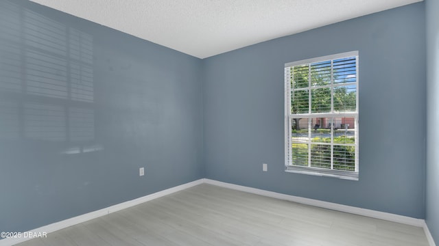 4 Starling Dr, Daytona Beach, FL 32117 - empty room featuring wood finished floors, baseboards, and a textured ceiling
