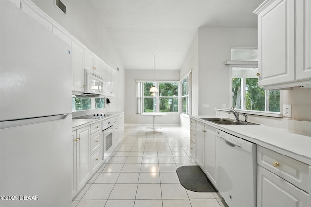 3776 Sweet Grove Ct, Port Orange, FL 32129 - kitchen with white appliances, white cabinetry, light countertops, light tile patterned floors, and pendant lighting