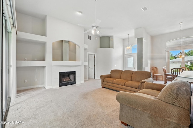 3776 Sweet Grove Ct, Port Orange, FL 32129 - carpeted living room with built in features, a tile fireplace, a high ceiling, and a ceiling fan
