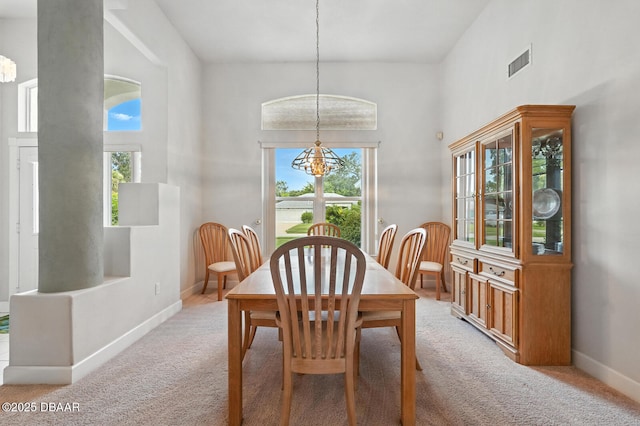 3776 Sweet Grove Ct, Port Orange, FL 32129 - dining space with a chandelier, light carpet, and a high ceiling