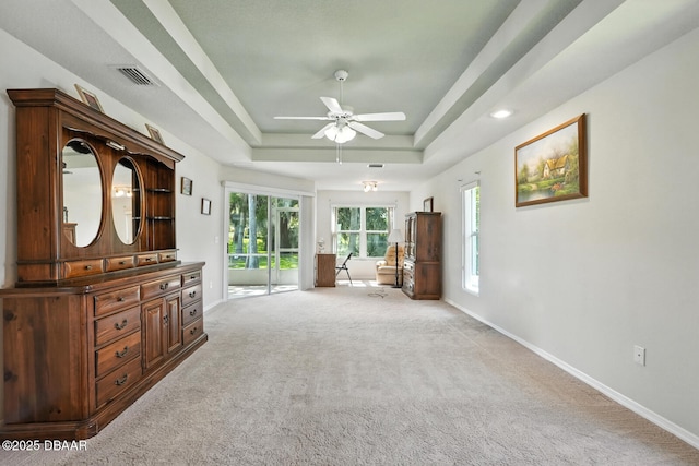 3776 Sweet Grove Ct, Port Orange, FL 32129 - living area with ceiling fan, light carpet, and a tray ceiling