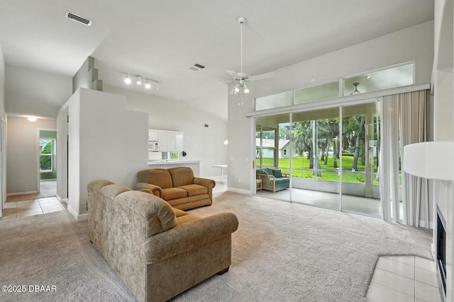 3776 Sweet Grove Ct, Port Orange, FL 32129 - living area featuring light colored carpet, ceiling fan, light tile patterned floors, and vaulted ceiling