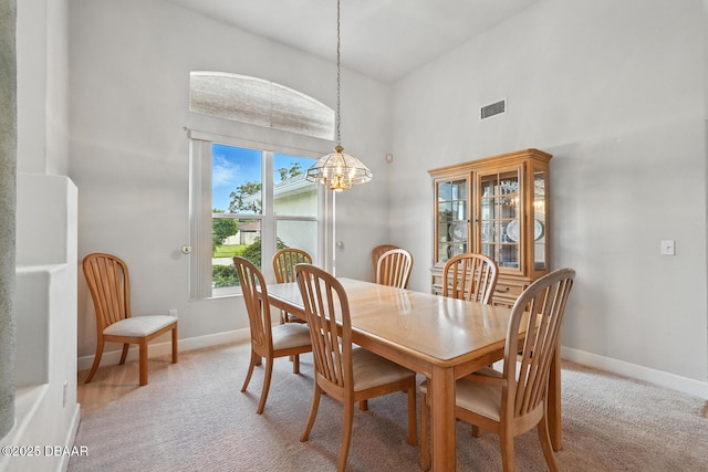 3776 Sweet Grove Ct, Port Orange, FL 32129 - dining room with a chandelier, light carpet, and a high ceiling