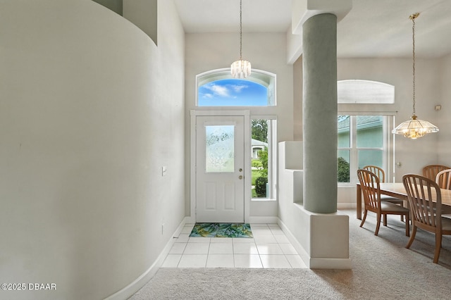 3776 Sweet Grove Ct, Port Orange, FL 32129 - foyer entrance featuring a chandelier, light colored carpet, light tile patterned flooring, and a towering ceiling