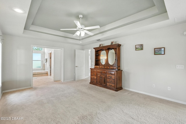 3776 Sweet Grove Ct, Port Orange, FL 32129 - unfurnished bedroom with a raised ceiling, light colored carpet, ensuite bathroom, and ceiling fan
