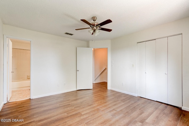 188 W Sandalwood Ct, Daytona Beach, FL 32119 - unfurnished bedroom featuring visible vents, a closet, baseboards, connected bathroom, and light wood-style flooring