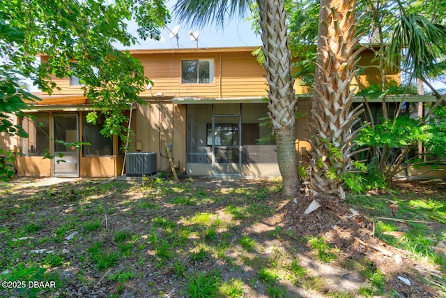 188 W Sandalwood Ct, Daytona Beach, FL 32119 - back of property featuring central AC unit, stucco siding, and a sunroom