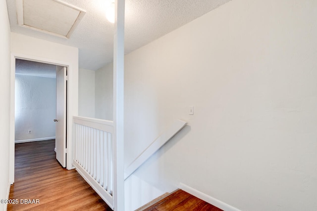 188 W Sandalwood Ct, Daytona Beach, FL 32119 - staircase with baseboards, attic access, and wood finished floors