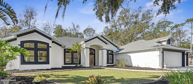 view of front of home with a garage and a front lawn