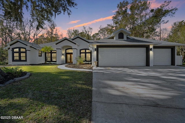 view of front facade featuring a garage and a yard