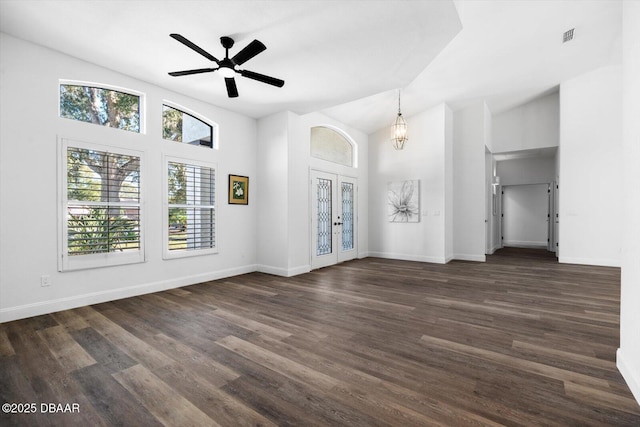 unfurnished living room featuring lofted ceiling, dark wood-type flooring, ceiling fan, and french doors