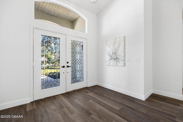 entryway with dark hardwood / wood-style flooring and french doors