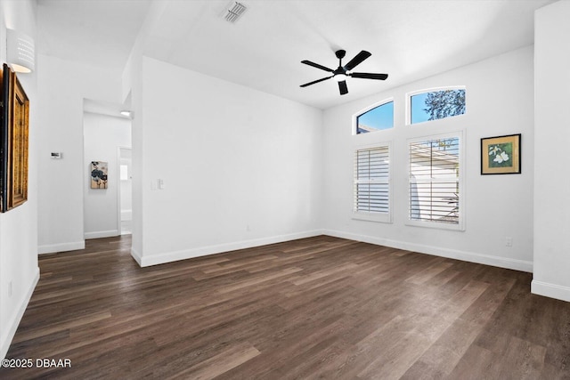 spare room featuring dark wood-type flooring and ceiling fan