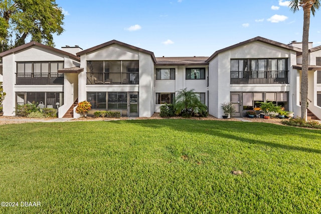 rear view of property with a lawn