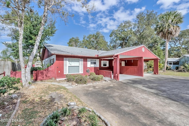 16 Red Maple Cir, Ormond Beach, FL 32174 - ranch-style home with concrete driveway, roof with shingles, fence, and a carport