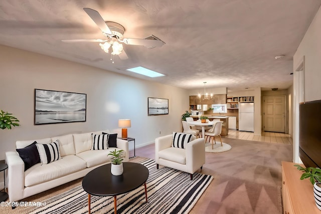 16 Red Maple Cir, Ormond Beach, FL 32174 - living area featuring light carpet, baseboards, a skylight, and ceiling fan with notable chandelier