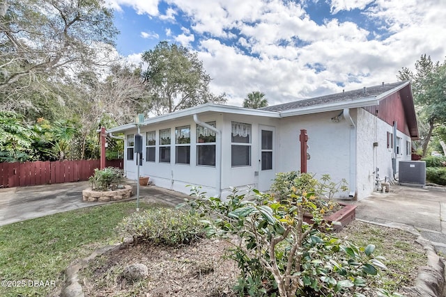 16 Red Maple Cir, Ormond Beach, FL 32174 - view of side of property with central air condition unit, a patio, stucco siding, and fence