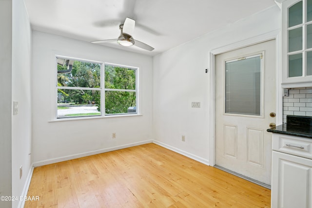 unfurnished room with ceiling fan and light wood-type flooring