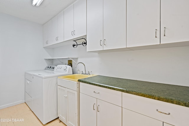 laundry room featuring cabinets, sink, and independent washer and dryer