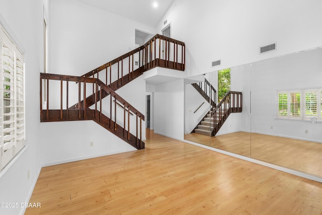 interior space featuring a high ceiling and wood-type flooring