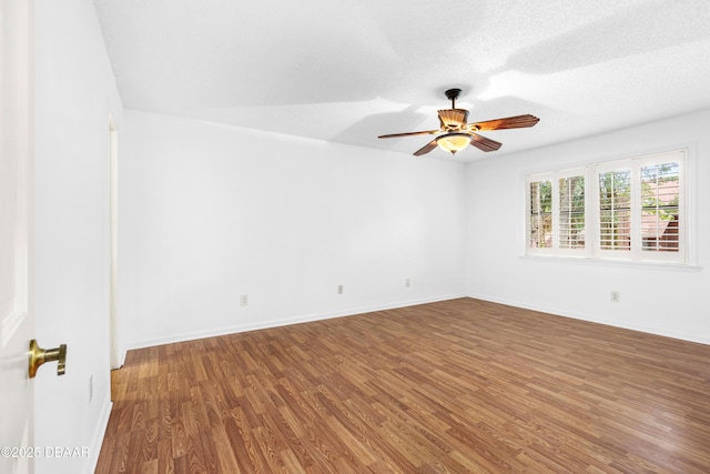 spare room with ceiling fan, wood-type flooring, and a textured ceiling