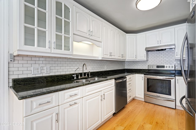 kitchen with light wood-type flooring, stainless steel appliances, white cabinetry, and sink