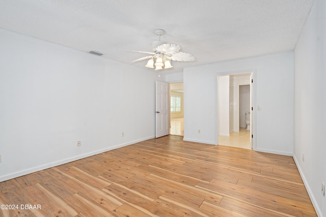 empty room featuring a textured ceiling, ceiling fan, and light hardwood / wood-style flooring