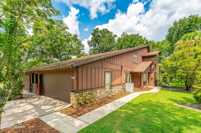 view of front of property with a garage and a front yard