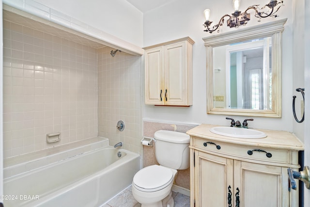 full bathroom featuring toilet, vanity, and tiled shower / bath combo