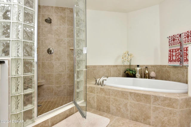 bathroom featuring independent shower and bath and tile patterned floors