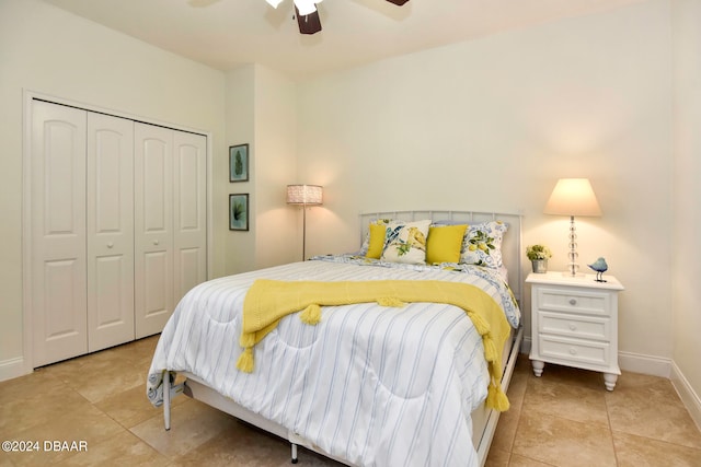 tiled bedroom featuring ceiling fan and a closet