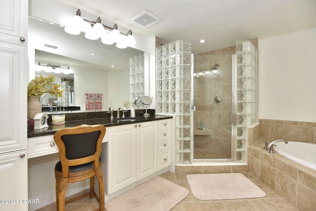 bathroom with vanity, independent shower and bath, and tile patterned floors