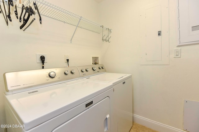 clothes washing area with electric panel and independent washer and dryer