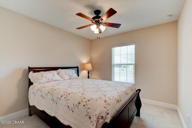 bedroom featuring light carpet, ceiling fan, and baseboards