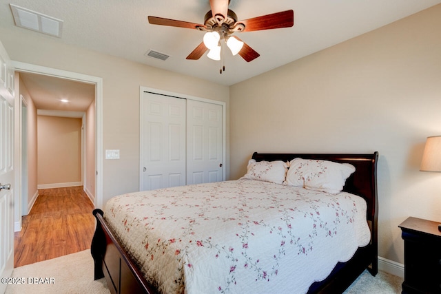 bedroom featuring baseboards, ceiling fan, visible vents, and a closet