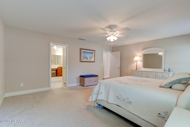 bedroom with ensuite bathroom, light carpet, a ceiling fan, visible vents, and baseboards