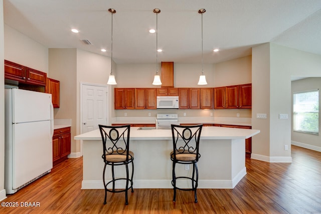 kitchen featuring light countertops, white appliances, light wood-style flooring, and visible vents