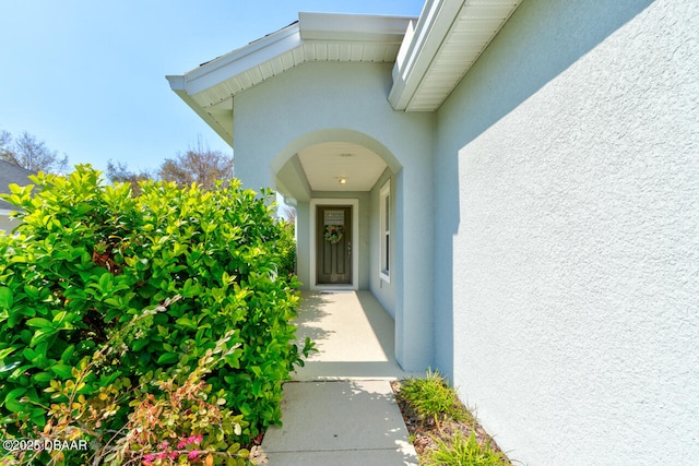 property entrance with stucco siding