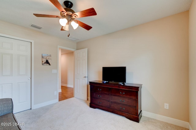 carpeted bedroom with ceiling fan, visible vents, and baseboards