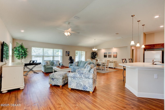 living room with light wood-style flooring, baseboards, vaulted ceiling, and recessed lighting