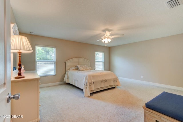 bedroom with carpet, visible vents, ceiling fan, and baseboards