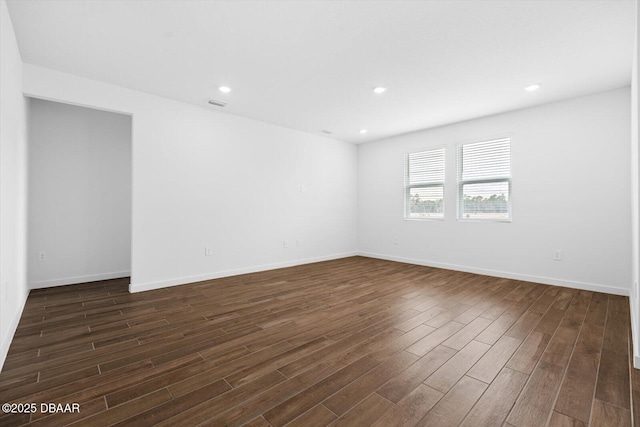 unfurnished room with dark wood-type flooring