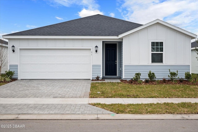 ranch-style house with a front yard and a garage