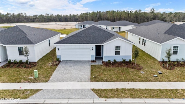 view of front of property with a garage and a front yard