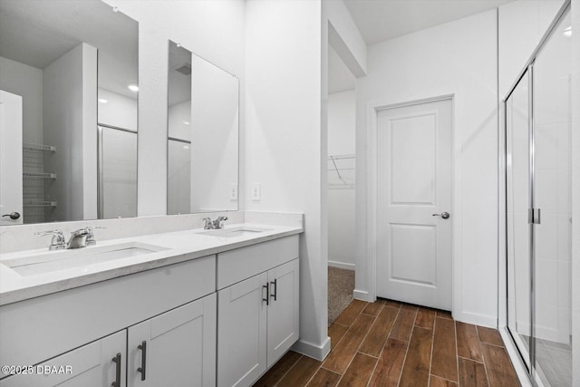 bathroom featuring vanity and an enclosed shower